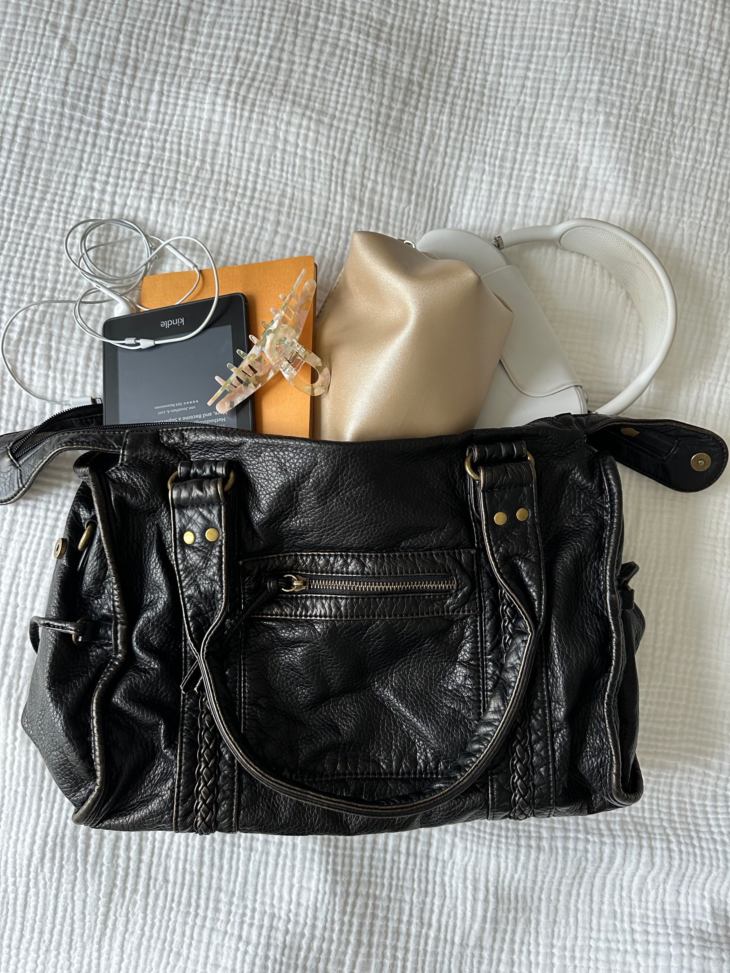 Black vintage-style weave bag with e-reader and pouch, contents shown