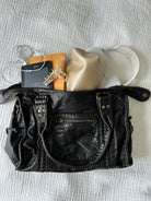 Black vintage-style weave bag with e-reader and pouch, contents shown