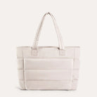 Beige quilted puffer tote bag, front view on plain background