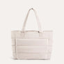 Beige quilted puffer tote bag, front view on plain background