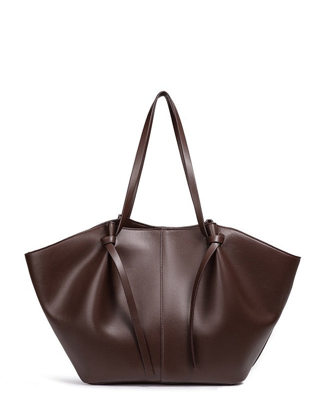 Dark brown leather tote bag with knotted strap detail, front view