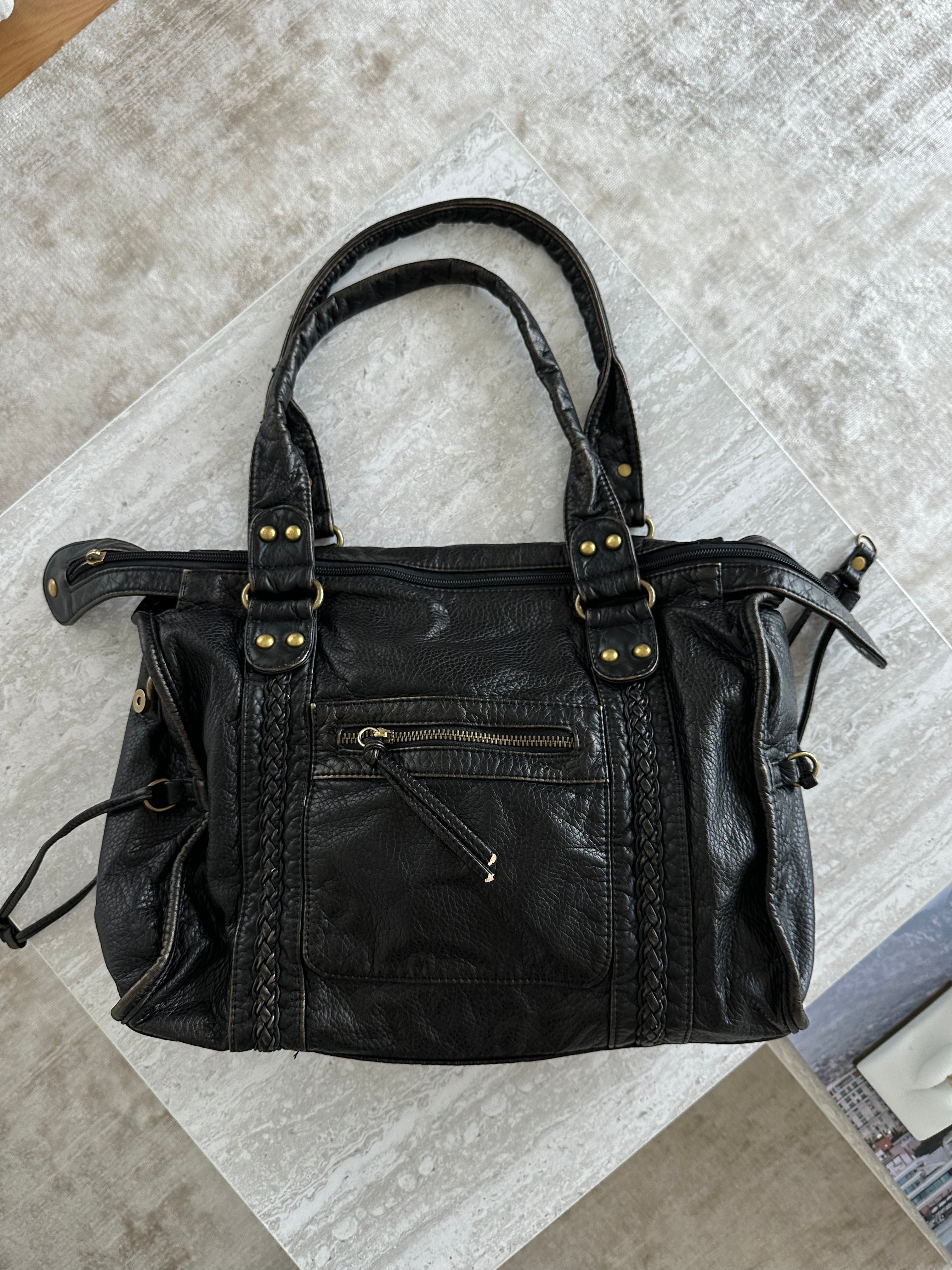 Black vintage-style weave bag on marble surface, top-down view