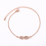 Rose gold angel wing bracelet, flat lay close-up