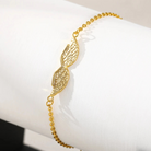 Gold angel wing bracelet, close-up detail on wrist