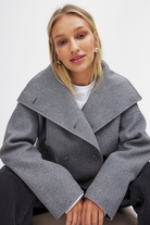 Close-up of grey double-breasted coat collar on model