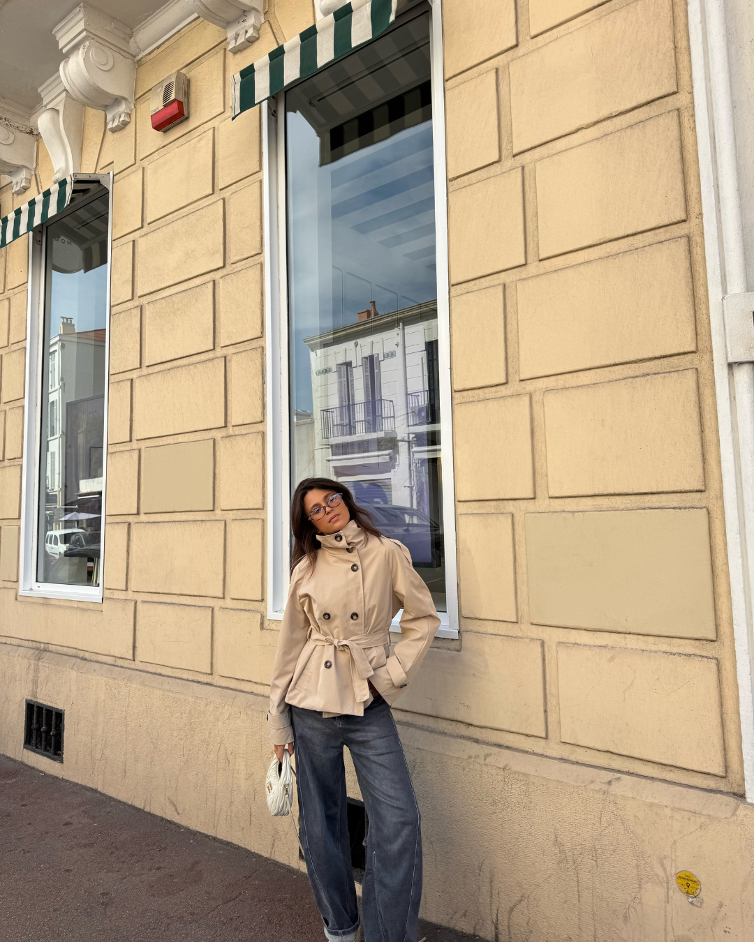 Beige short belted trench coat, full-length front view outdoors
