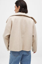 Light beige double-breasted cropped coat, back view on model