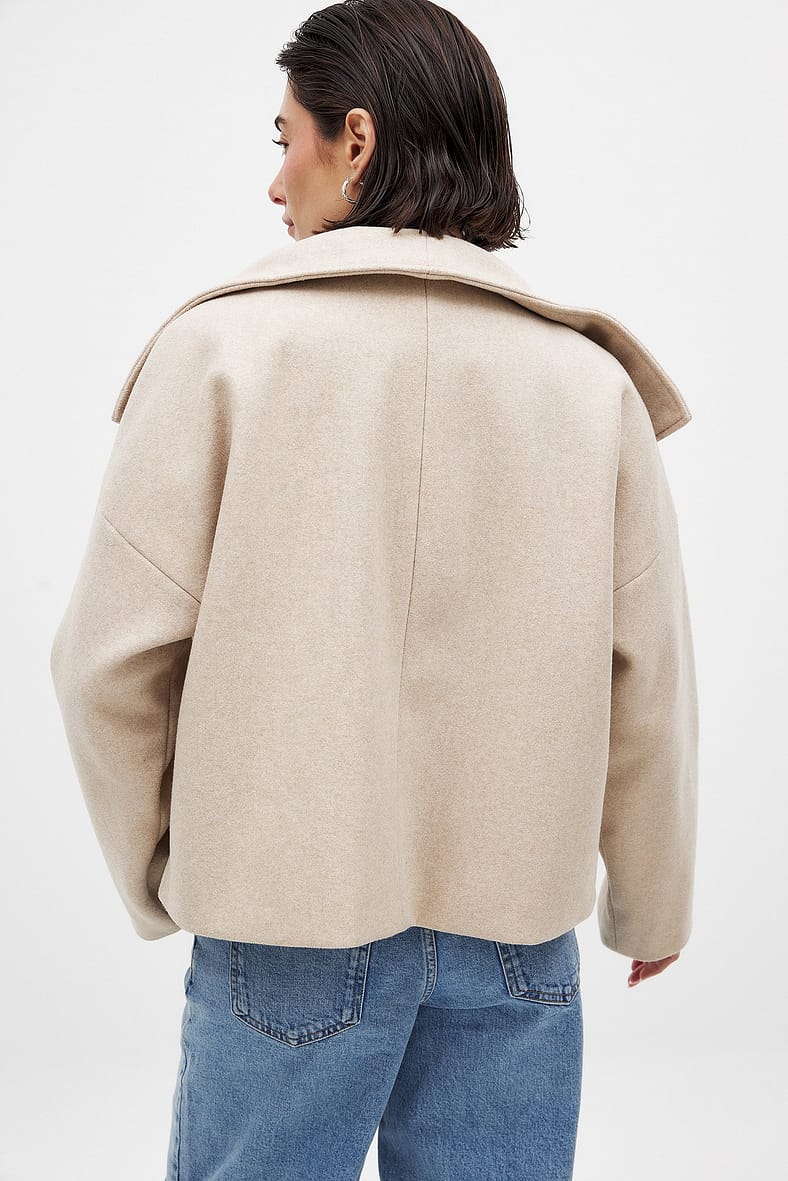 Light beige double-breasted cropped coat, back view on model