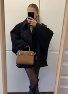 Black oversized coat, mirror selfie with tan handbag