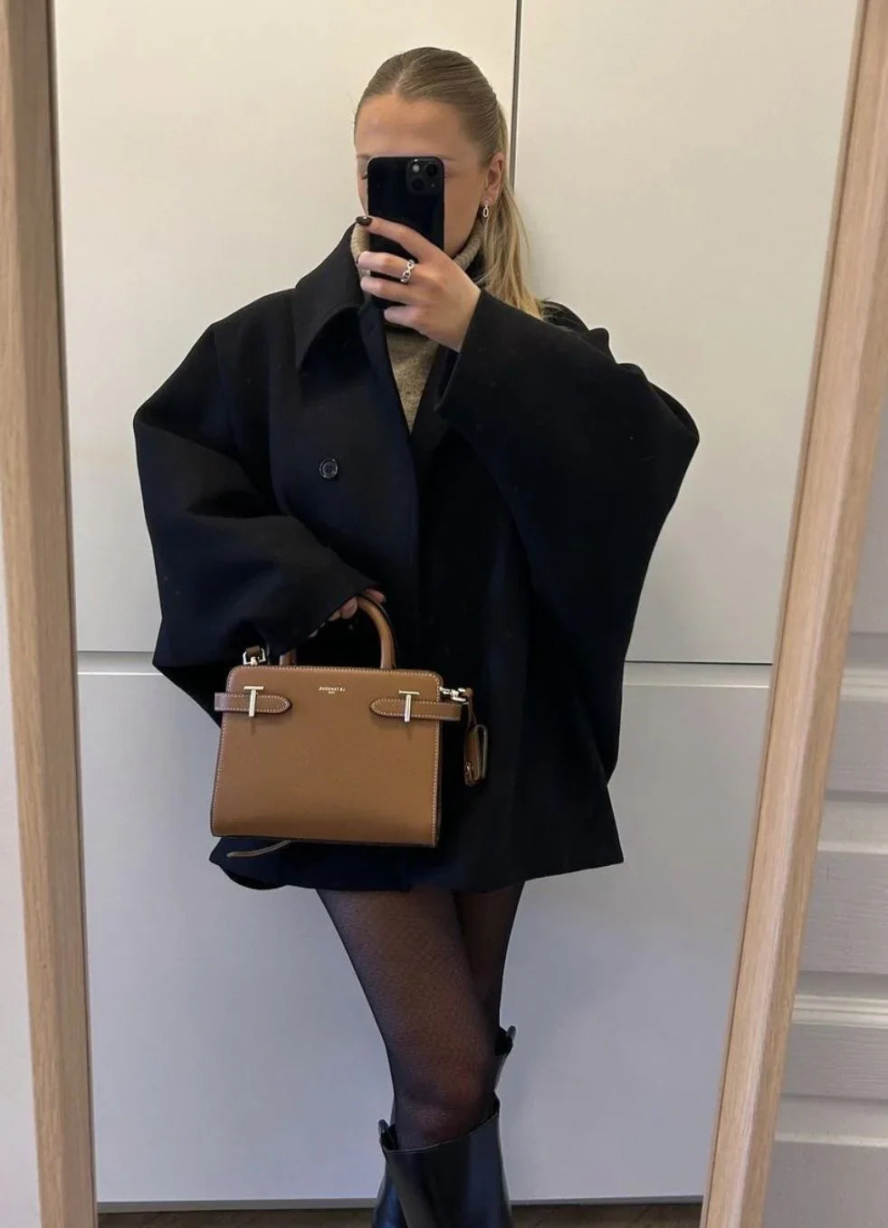 Black oversized coat, mirror selfie with tan handbag