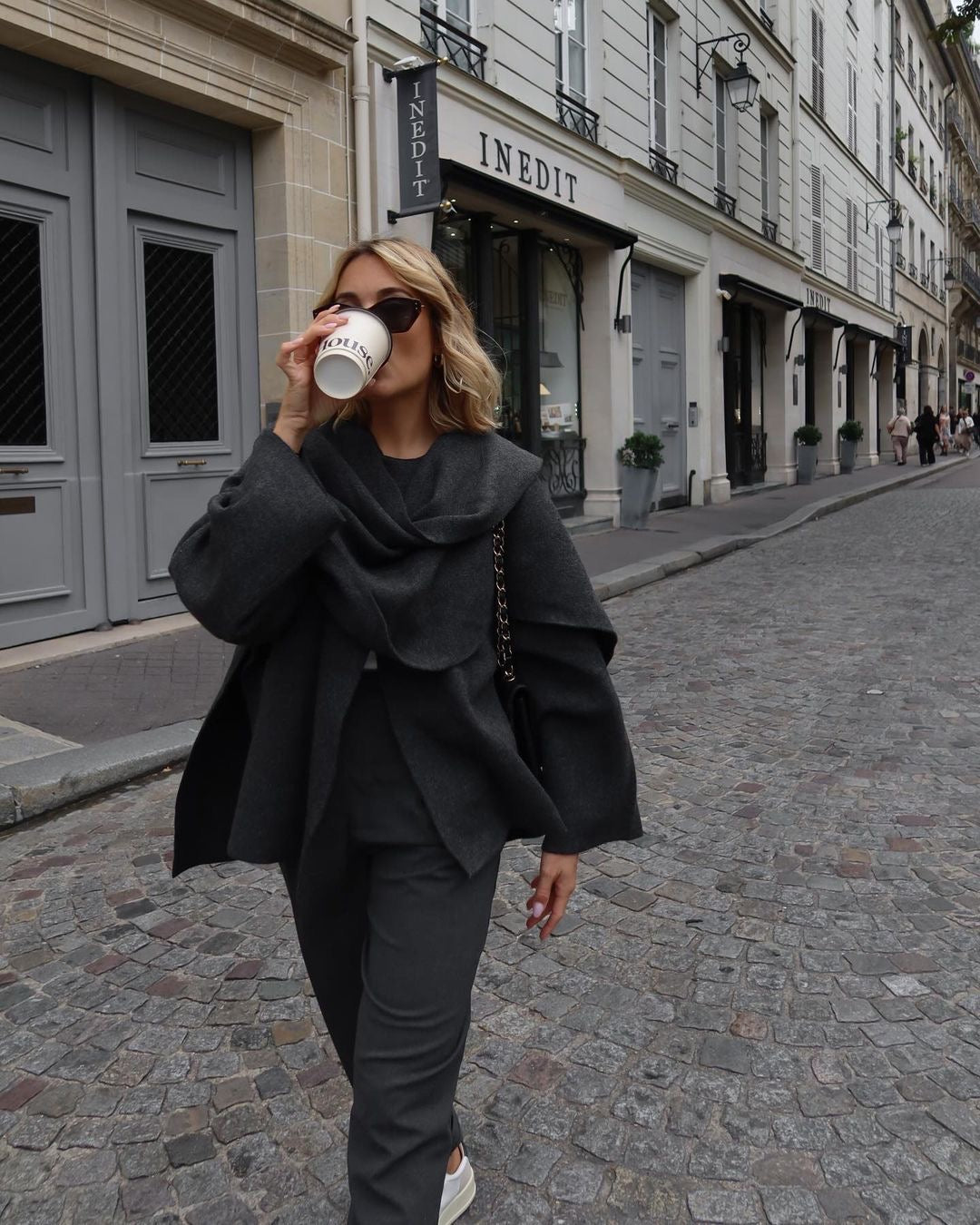 Charcoal short cape, full-length front view on model walking