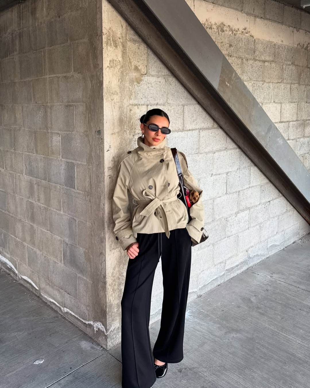 Beige short belted trench coat, model on city street