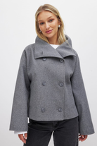 Grey double-breasted cropped coat, front view on model