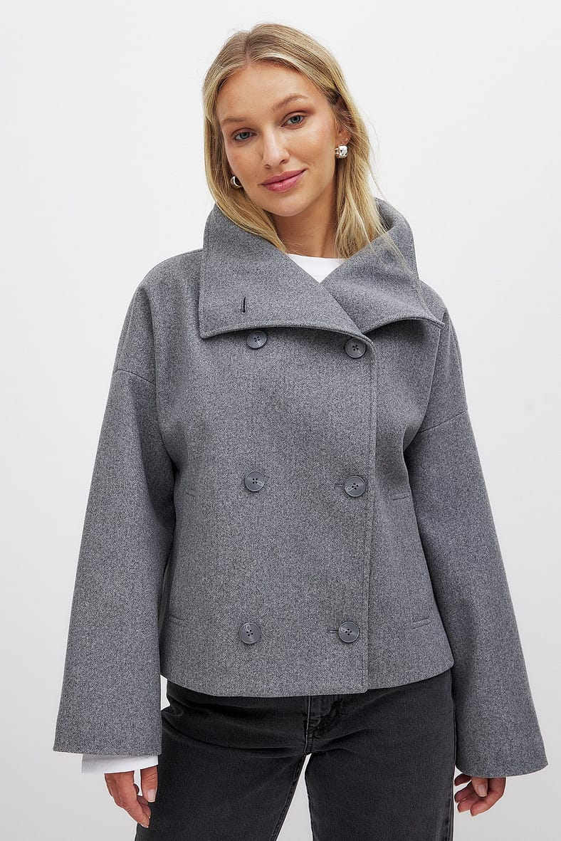 Grey double-breasted cropped coat, front view on model