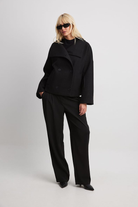 Black double-breasted cropped coat, full-length front view