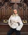 Sand short trench coat with belted waist, front view on model