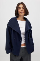 Navy double-breasted cropped coat, front view on model