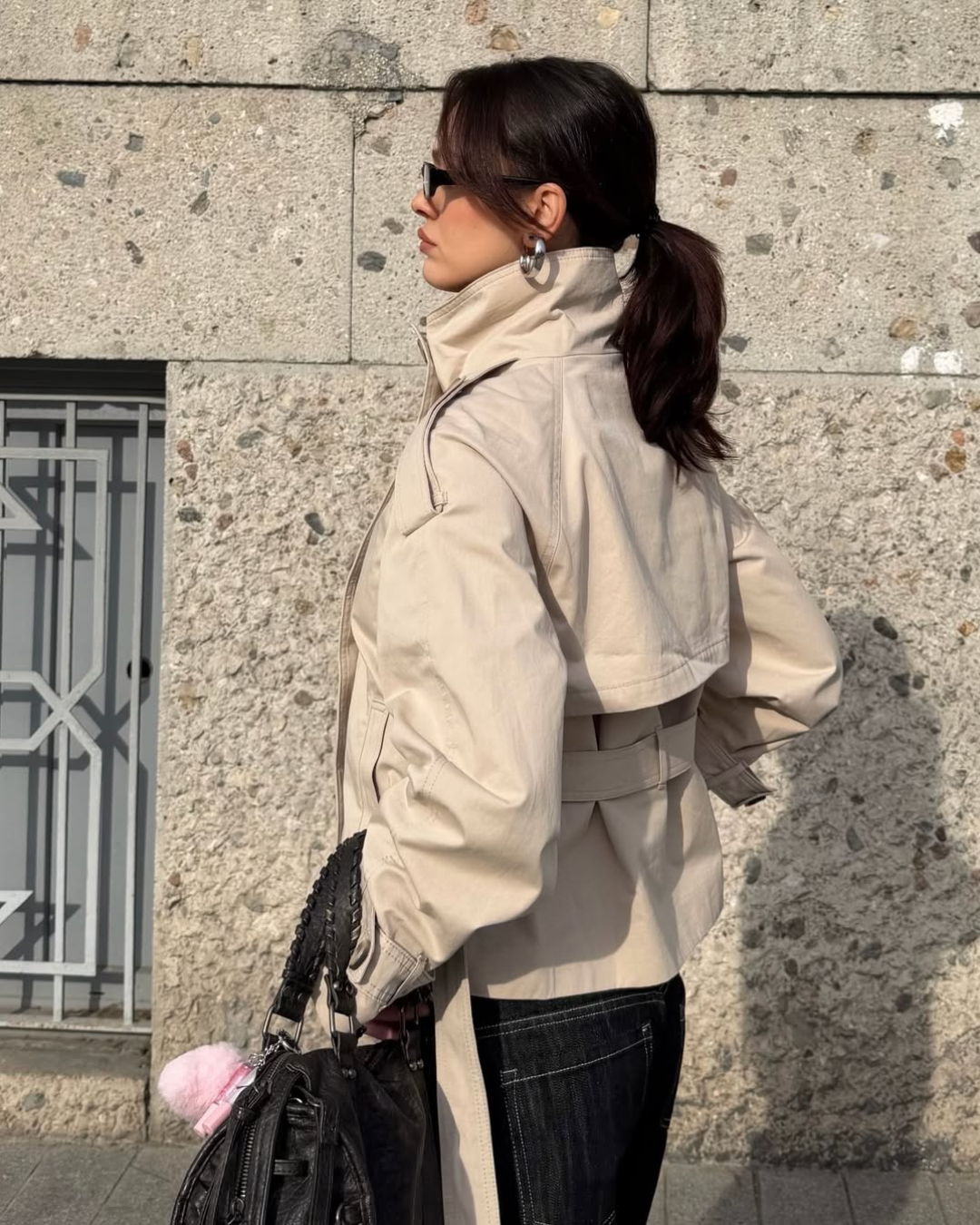 Sand short trench coat with belted back yoke, back view on model