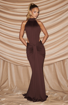 Mocha halter maxi dress with cutout waist, front view against curtain