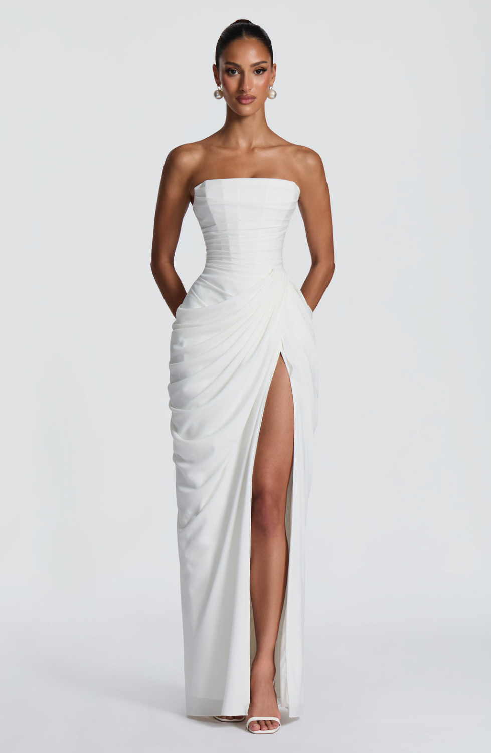 Ivory strapless maxi dress with thigh-high split, front view on model