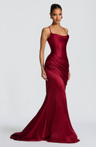 Burgundy satin gown with ruched skirt, side view on model