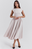 French dove grey full-skirt midi dress, front view with hands clasped