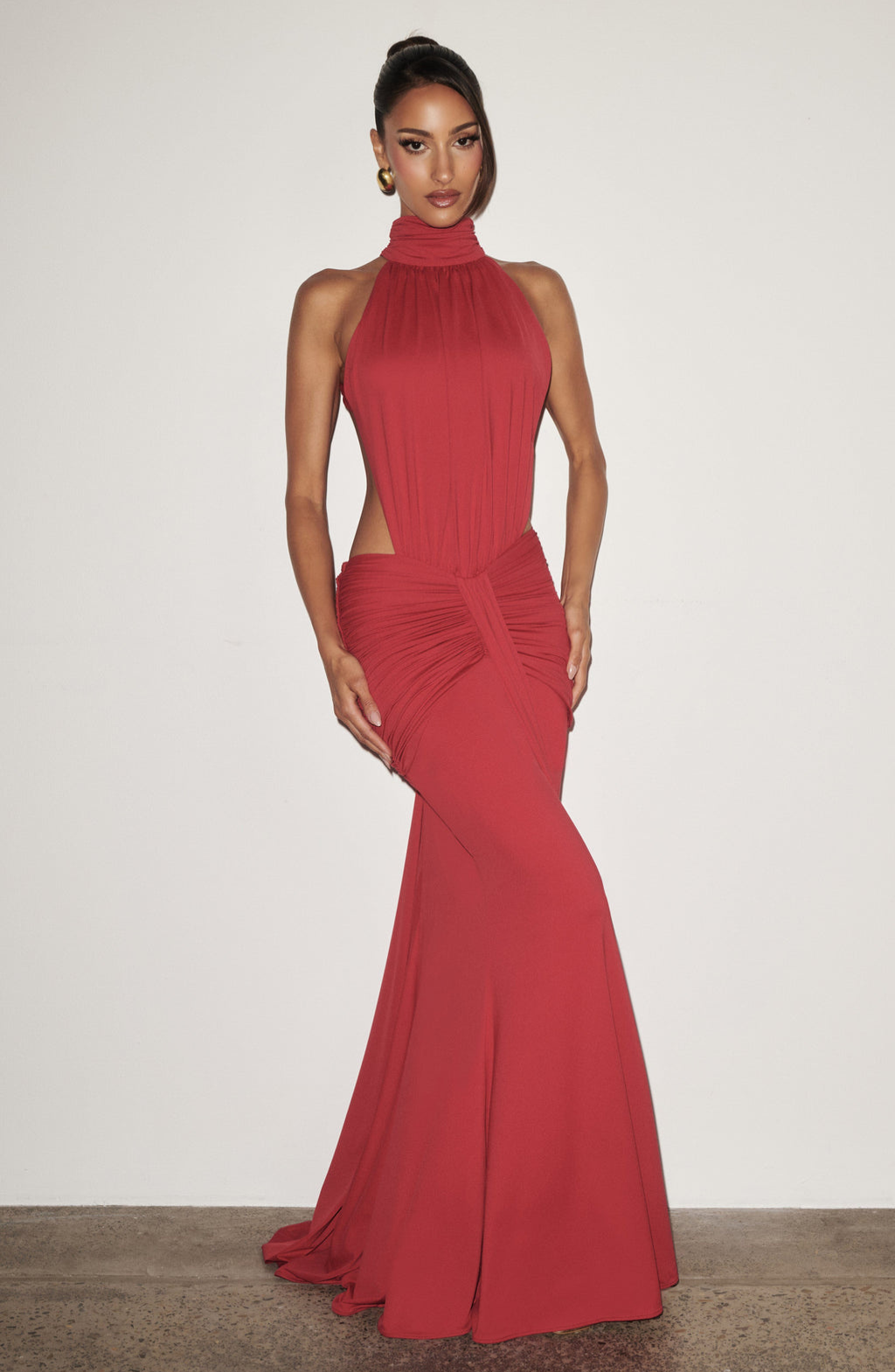 Red halter maxi dress with cutout waist, studio front view