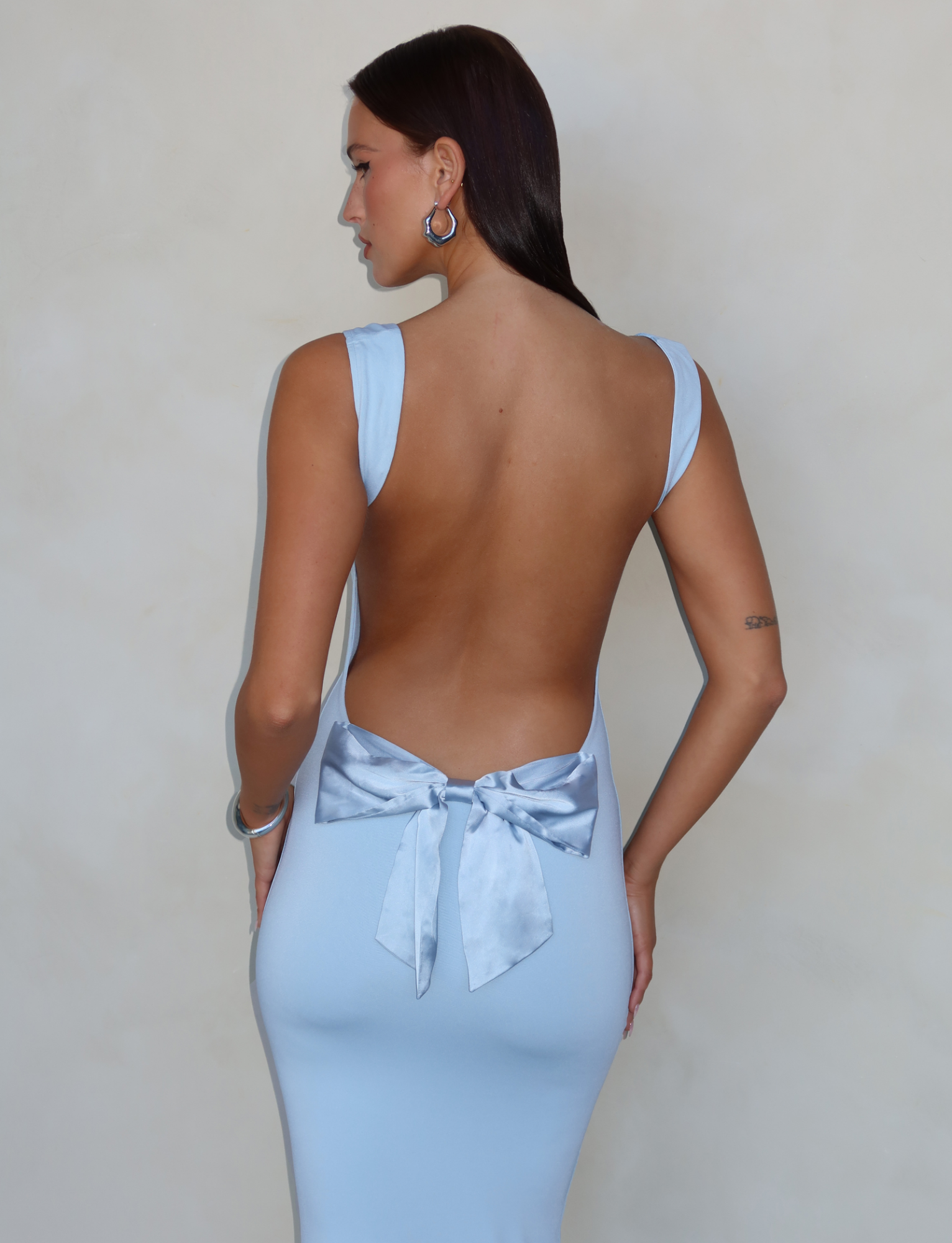 Baby blue maxi dress with open back and bow, back view on model