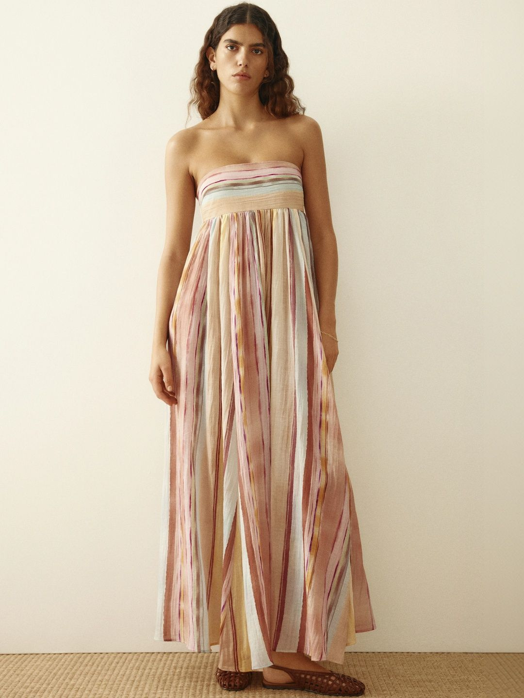 Strapless maxi dress in pink, blue and rust stripes, front view on model