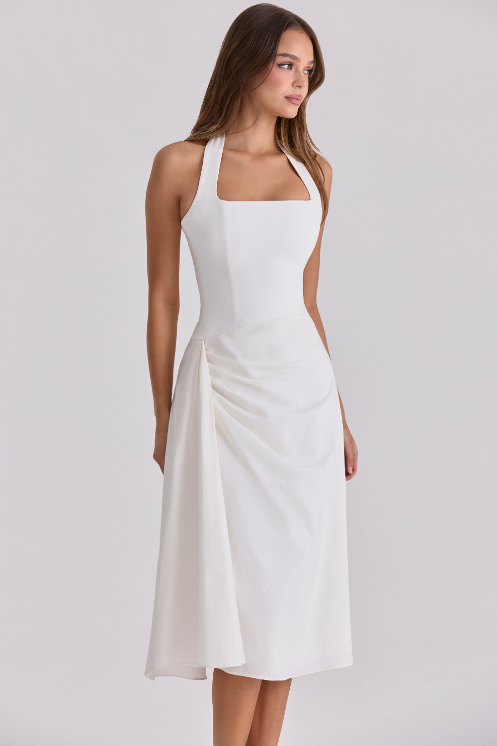 Ivory halter-neck midi dress with draped detail, side view on model