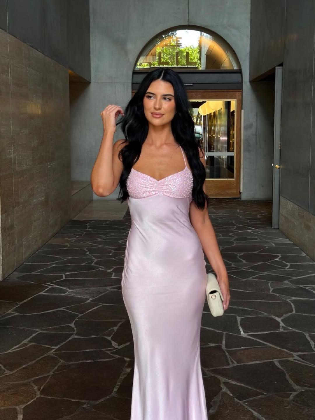 Pink satin slip maxi dress, model walking through archway