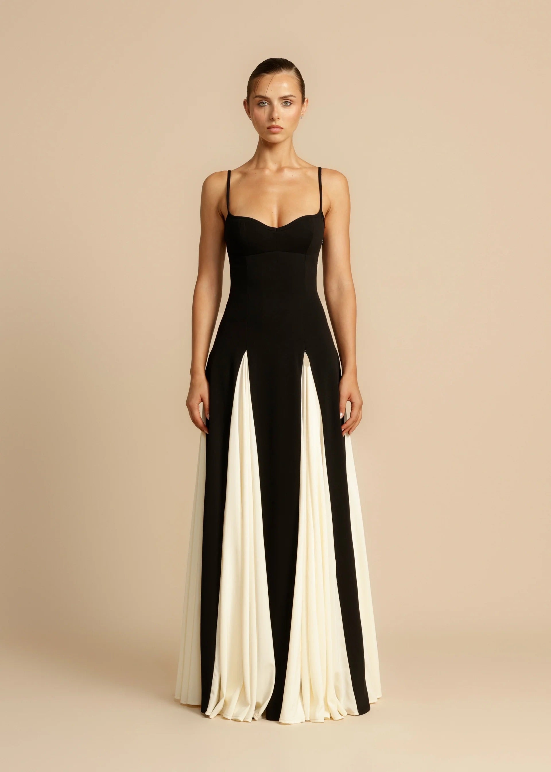Black maxi dress with ivory pleated godets, straight-on view on model