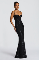 Black fitted maxi dress with floral lace embroidery, side view on model