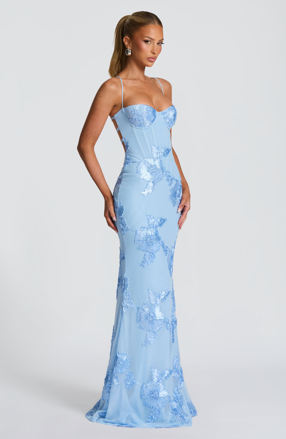 Baby blue fitted maxi dress with floral lace embroidery, side view on model