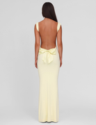 Lemon yellow maxi dress with open back and bow detail, back view on model
