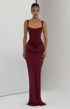 Burgundy corset-style maxi dress on model, full length studio