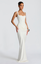 Ivory corset-style maxi dress on model, side view
