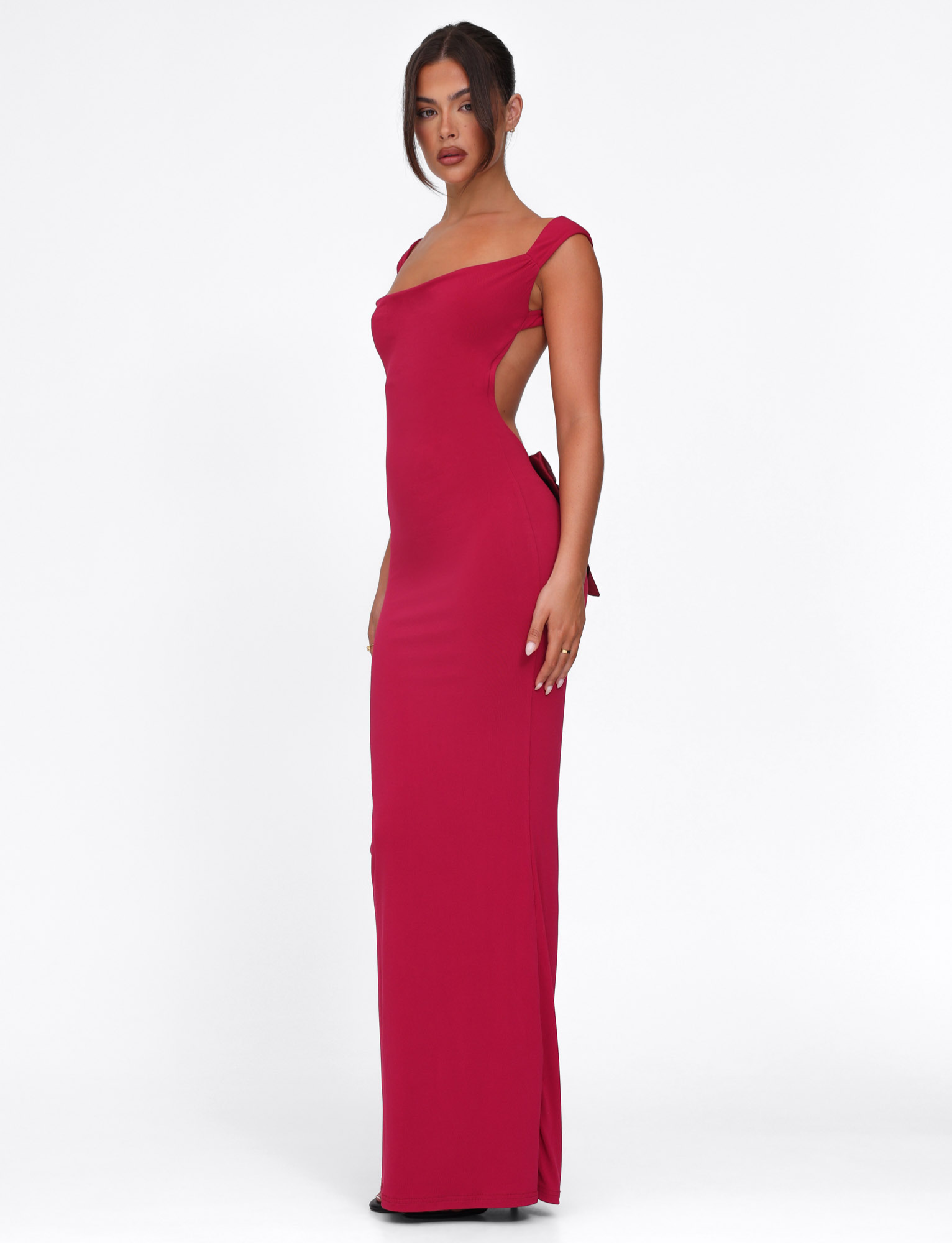 Deep red maxi dress with side bow cutout, side view on model