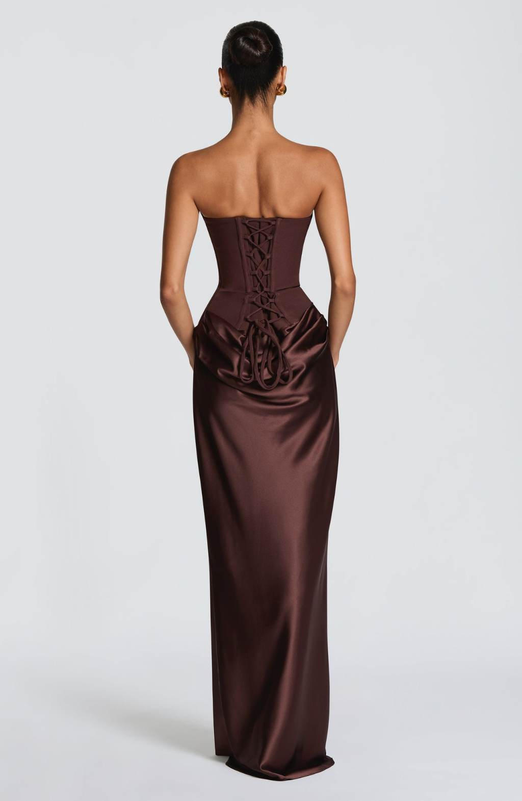 Back view of chocolate brown satin maxi dress showing lace-up corset back