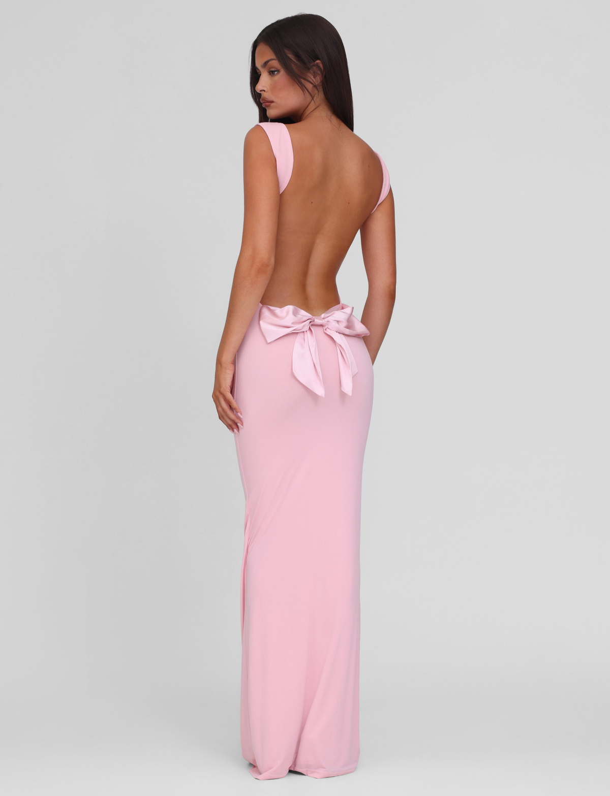Baby pink maxi dress with open back and bow detail, back view on model