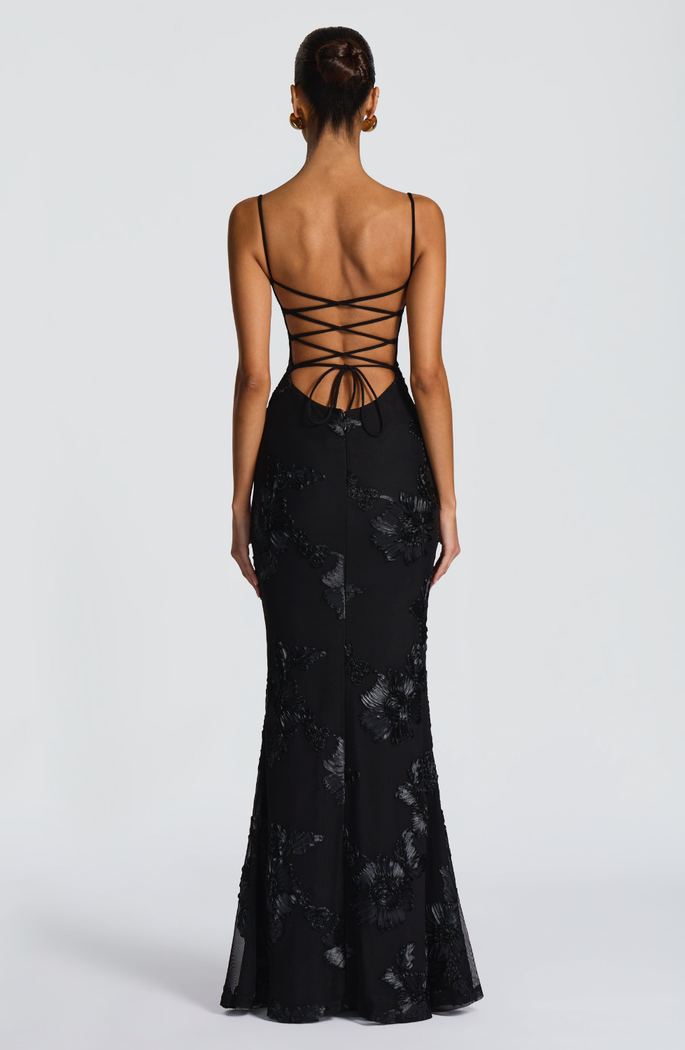 Black fitted maxi dress with lace-up open back, back view on model