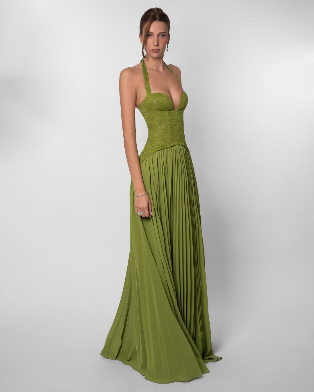 Olive green lace corset maxi dress with pleated skirt, three-quarter view on model