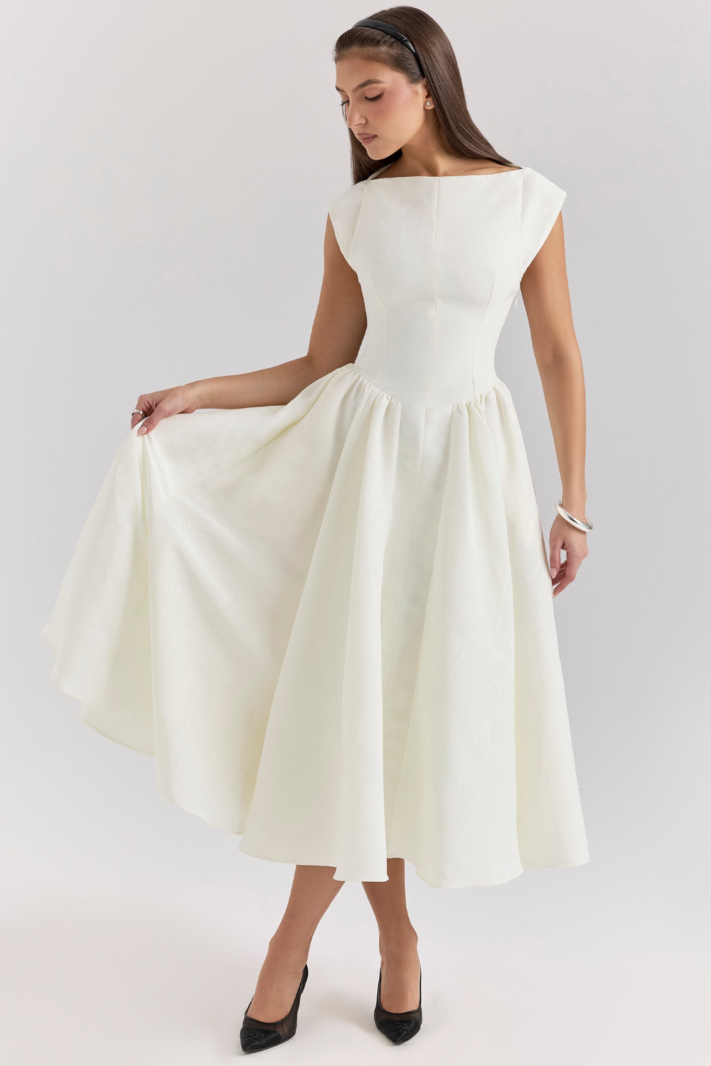Ivory full-skirt midi dress, model holding out the skirt