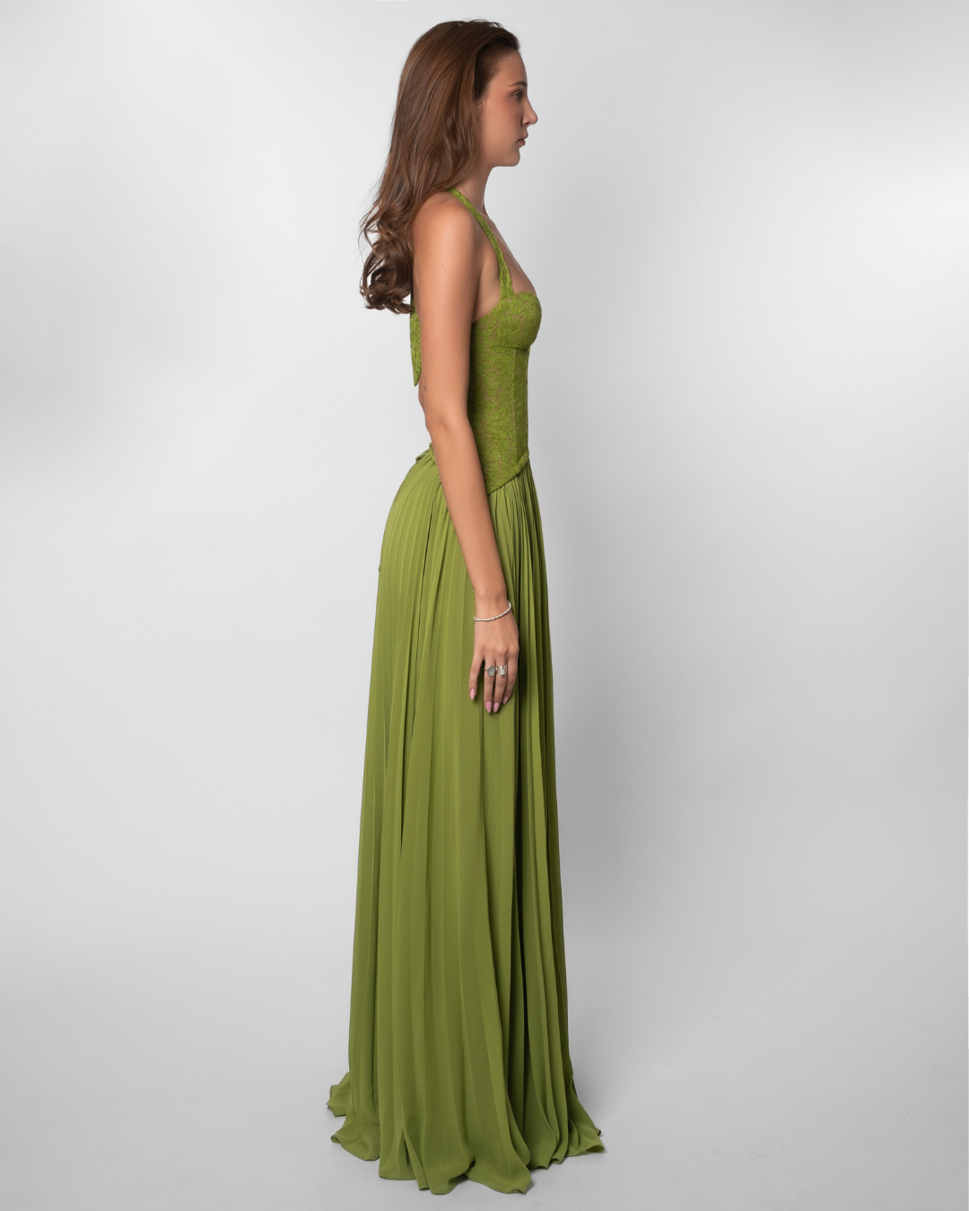 Olive green lace corset maxi dress with pleated skirt, side view on model