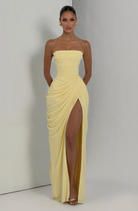 Lemon strapless maxi dress with thigh split, model indoors