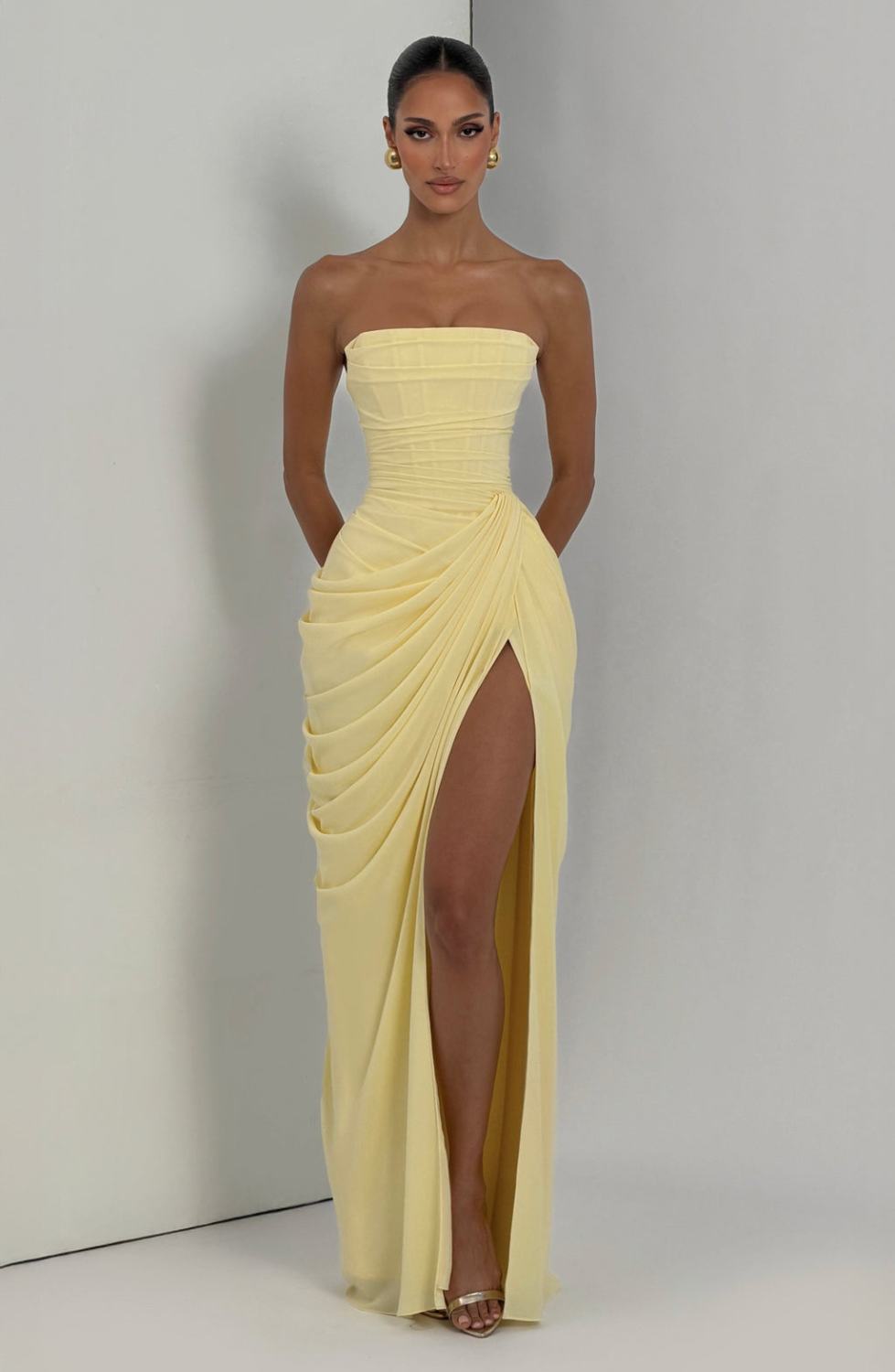 Lemon strapless maxi dress with thigh split, model indoors