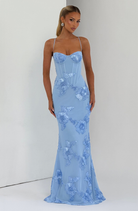 Baby blue fitted maxi dress with floral lace embroidery, model indoors