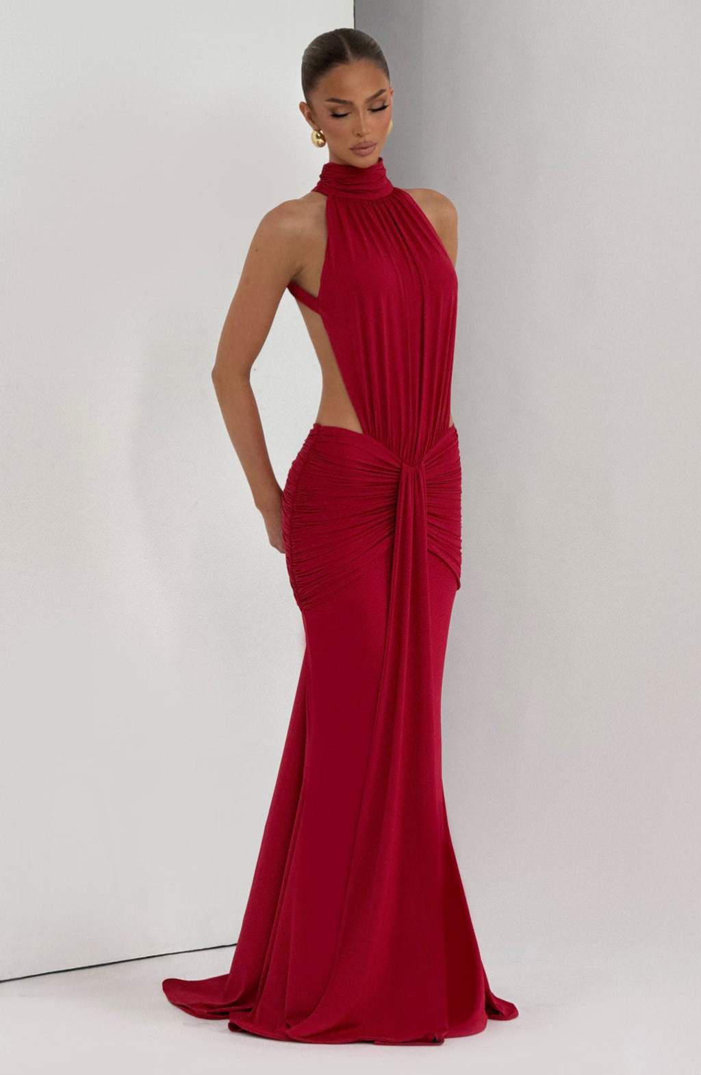 Red halter maxi dress with side cutout, three-quarter view, eyes closed