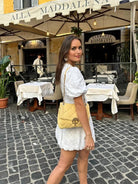 White embroidered mini dress, back and side view on model