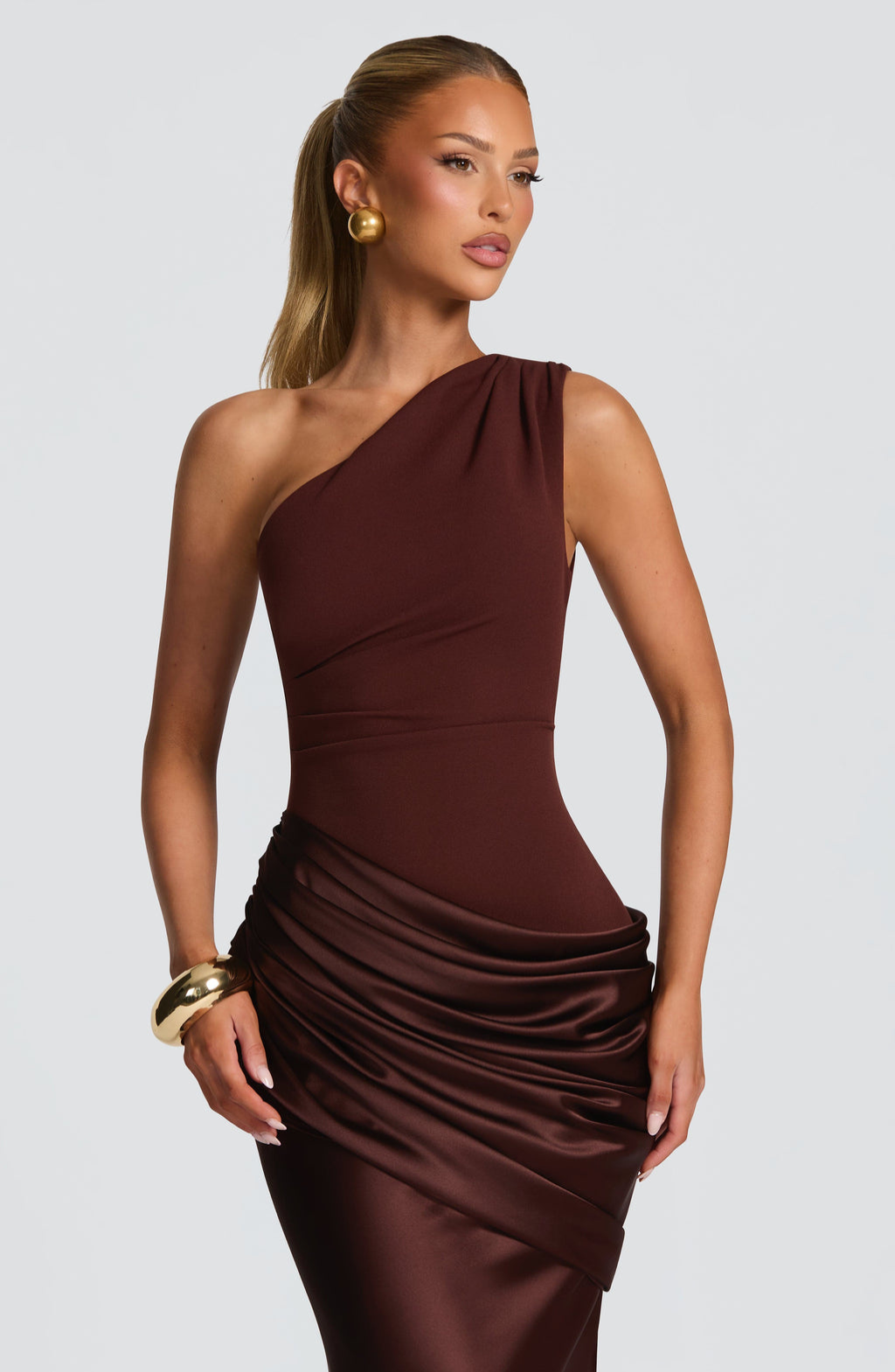Close-up of mocha satin ruched waist on one-shoulder dress